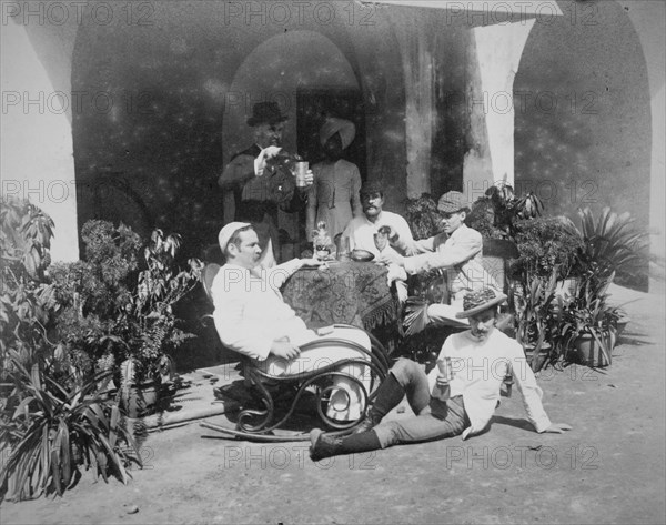 Group of European men relaxing outside building in Calcutta