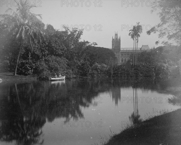 Scene showing rowing boat on a river and tropical gardens in Calcutta