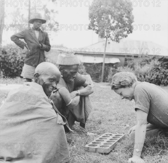 Elspeth Huxley plays a mancala game