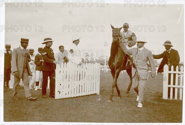 Group of men with jockey on horse, Colombo