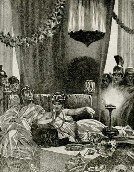This 1912 images shows Cleopatra dropping a pearl into a golblet of wine. The Roman writer Pliny the Elder, in his Natural History, told of Cleopatra betting Marc Antony that she could host the most expensive dinner in history. To impress Antony and the Roman Empire he represented with the extent of Egypt's wealth., she crushed one large pearl from a pair of earrings and dissolved it in a goblet of wine (or vinegar), before gulping it down (the subject of this illustration.) Cleopatra VII (69-30 B.C.), the daughter of Ptolemy XI, of Egypt. She married her brother Ptolemy XII and began to rule Egypt with him when she was 17. She later aligned her elf with Julius Caesar against her brother. Following Caesar's death, she aligned herself with Mark Antony. Following Antony's death, she is said to have killed herself, as legend has it, by the bite of an asp.