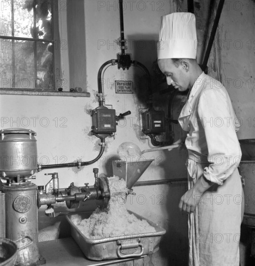 Cook at work in large kitchen; soup kitchen; 1941.