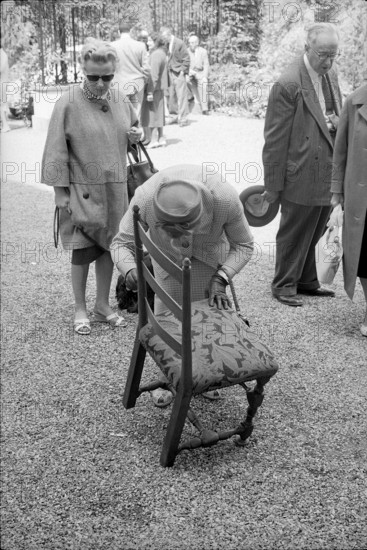 Wartegg castle; woman looking at a upholstered chair; 1962.
