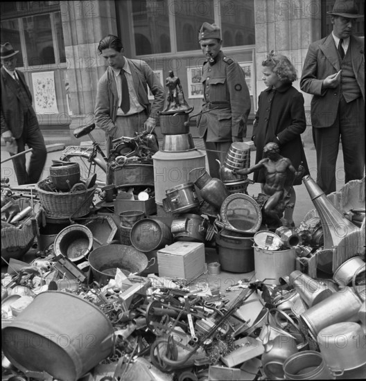 Collect of of non-ferrous metal; pile of metal articles; 1942.