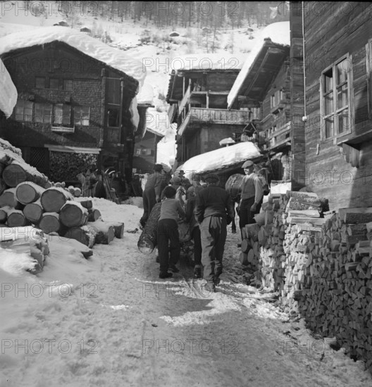 Lotschental, men transporting log; 1941.