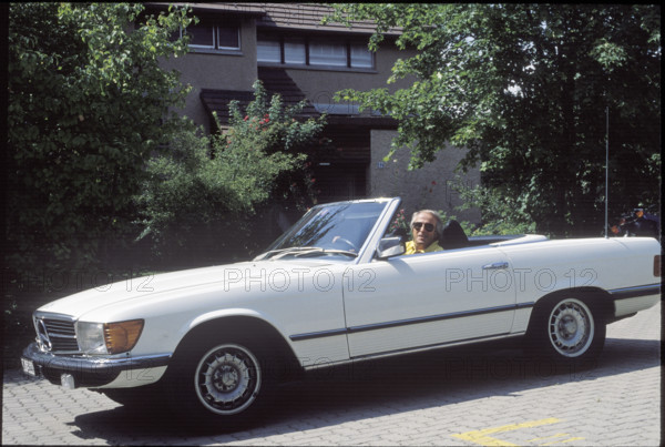 Walter Andreas Muller in his Mercedes convertible 1990.