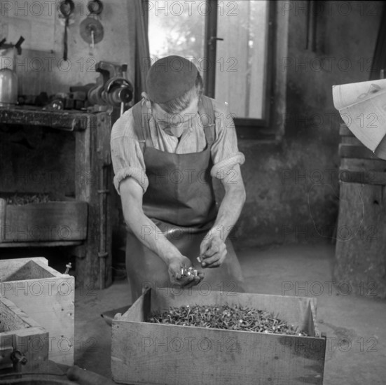 Forge, nailer making nails; 1940.