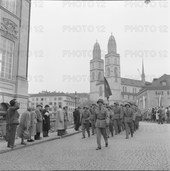 Military officers marching across Munsterbrucke, Zurich 1957.