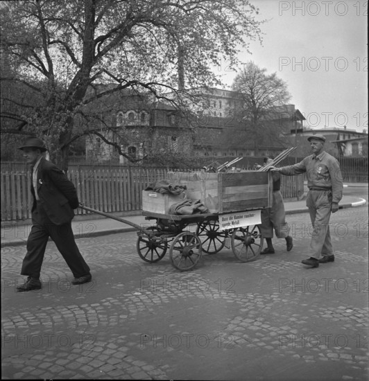 Men gathering non-ferrous metal, handcart; 1942.