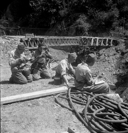 After high water: pioneer troop building temporary bridge, Riazzino 1948.