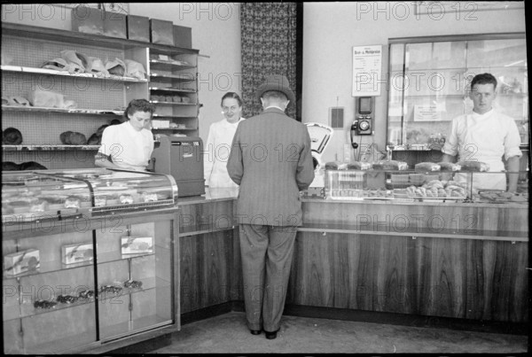Customer in baker's shop; around 1940.