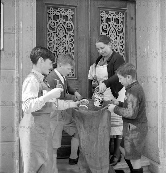W K 2: war economics; young people collecting material to be recycled.