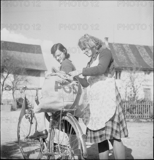 WW2 : farming camp; girl, young woman, mail, postal bag on bicycle, 1943.
