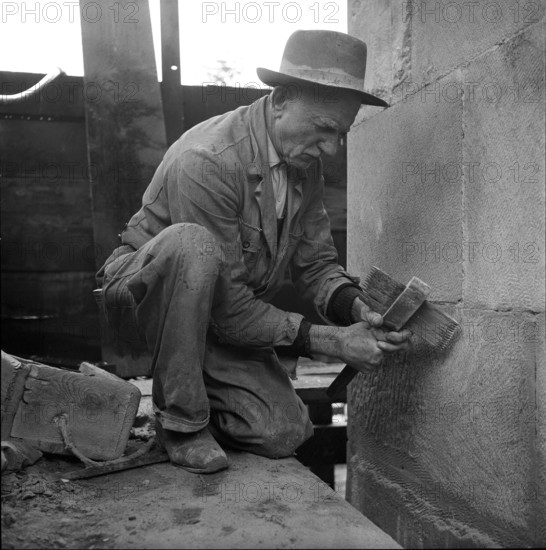 Stonemason working on facade, Lausanne 1957.