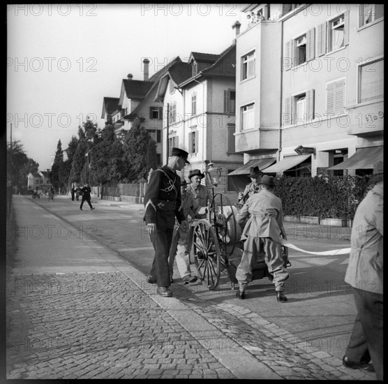 War fire brigade: men with hose cart, 1939.