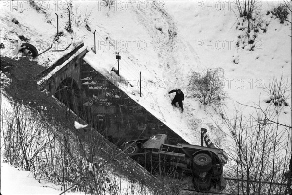 Truck lying on rails in front of tunnel entrance 1969.