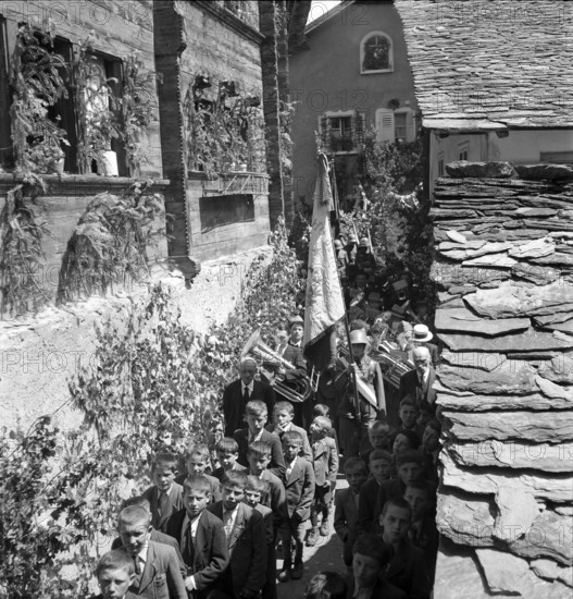 Procession with brass band on Corpus Christi in the Valais village Ayent, 1943.