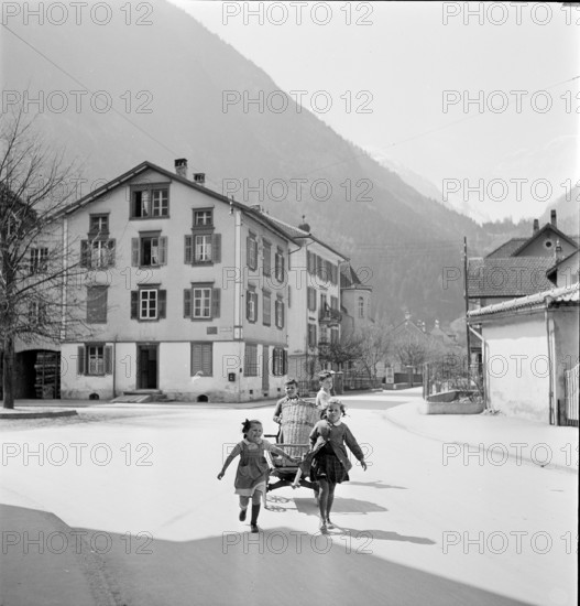 Girls carrying wooden handcart in Erstfeld; 1942