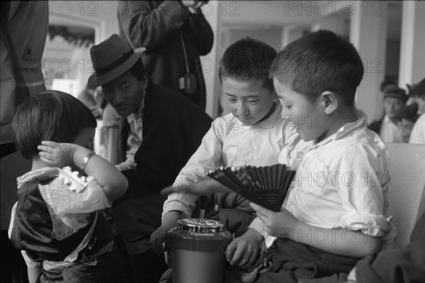 Tibetan boys playing with ashtray at Zurich airport 1963