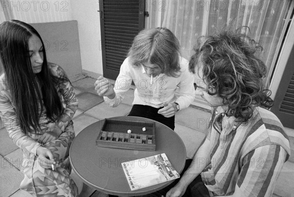 Young adults playing a board game, 1972