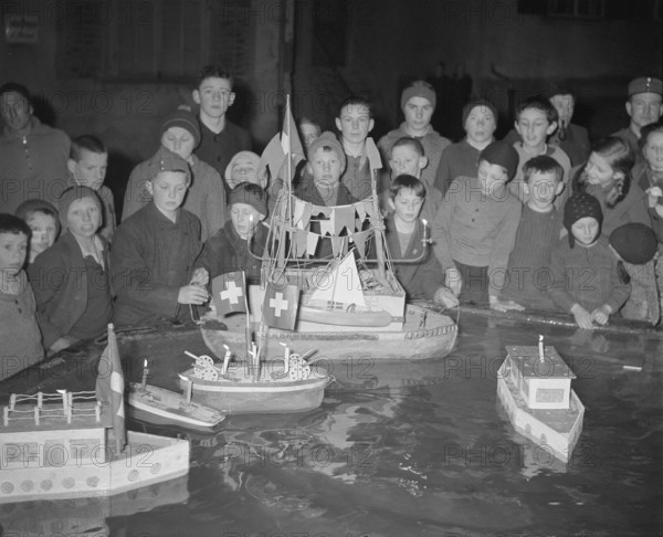 Boys playing with model boats, 1941