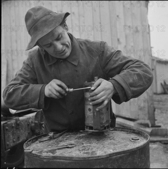 Worker repairing starter engine, Rheinau 1953