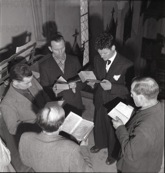 Men singing during mass on St. Barbara day in Salins