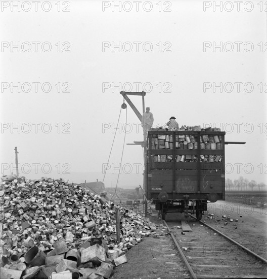 WW2: economy of war; inmates unloading used metal