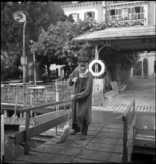 Man cleaning the landing stage after cattle transport, 1941