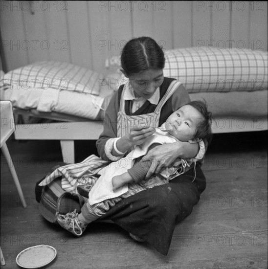 Tibetan woman feeding her baby, Waldstatt 1963