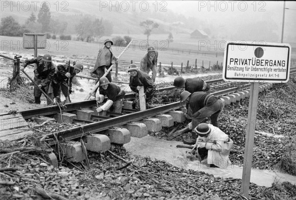 Soldiers repairing bad weather damage to railroad track in 1969