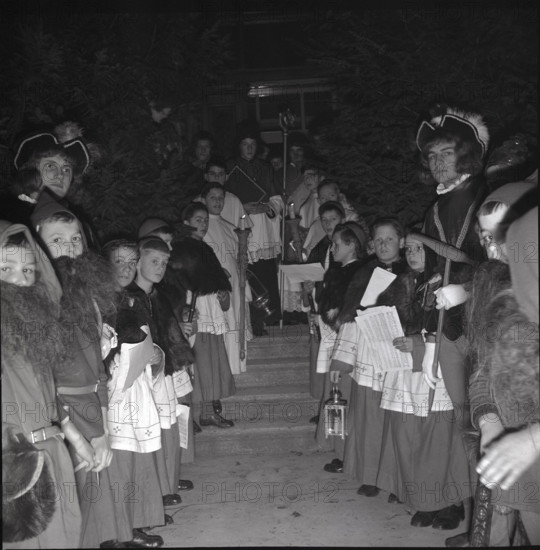 Children in historical costumes wait for Santa Claus in 1941