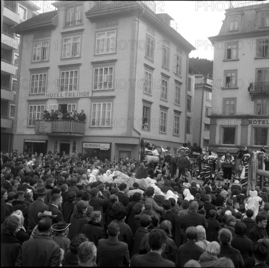 Throwing bread to the crowd, carnival custom in Einsiedeln, 1965