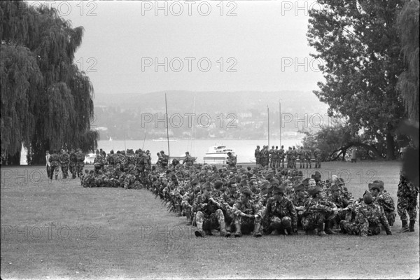Military Parade 1969 in Switzerland: Soldiers having a rest in a park
