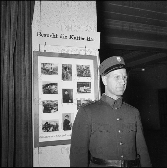 Watchman in front of advertising inside Kunsthaus Zurich 1954
