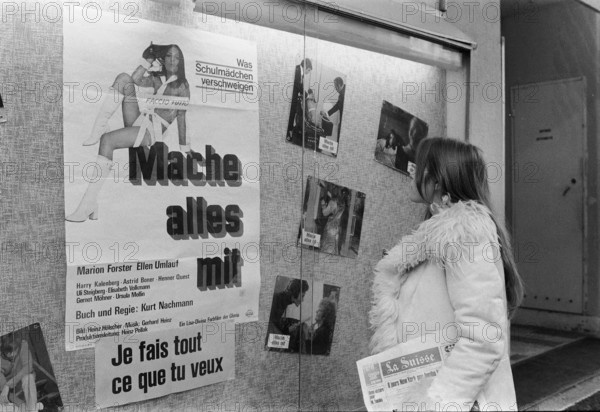Woman watching the showcase of sex cinema Splendid, Geneva 1972