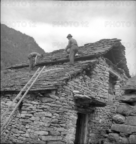Frasco in the Verzasca valley, men repairing stone roof; 1942