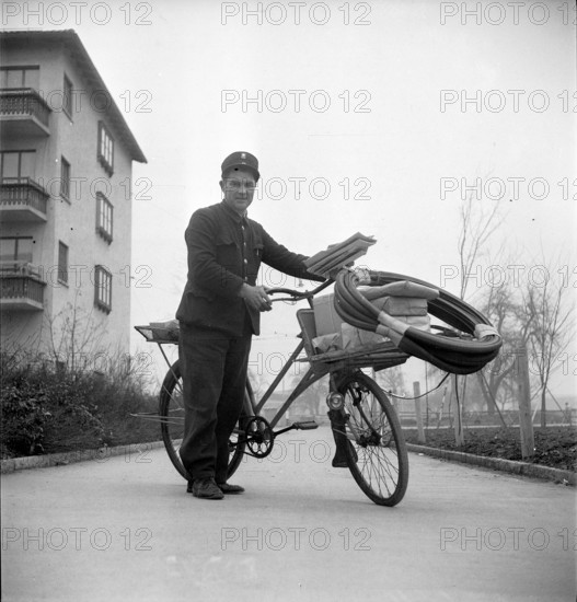 Postman with his bicycle; 1947