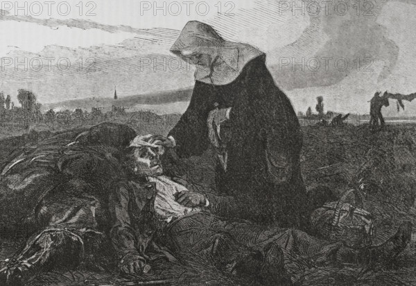 Franco-Prussian War (1870-1871). Sisters of Charity on the battlefield, tending to the wounded. Engraving. ""Historia de la Guerra de Francia y Prusia"" (History of the War between France and Prussia). Volume I. Published in Barcelona, 1870.