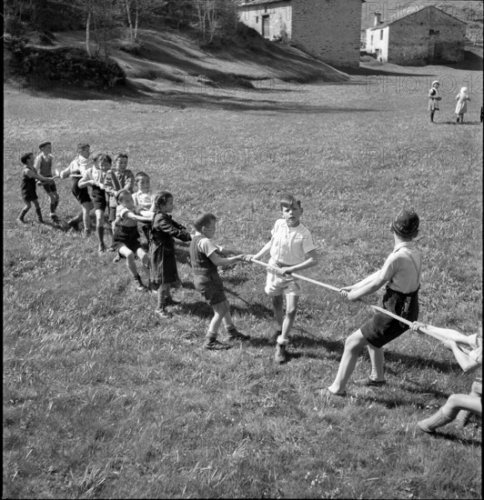 Children playing tug of war, 1942