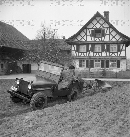 Military jeep pulling plow 1950