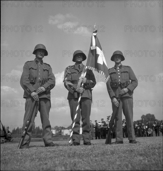 Three soldiers with the Swiss flag, Payerne 1949