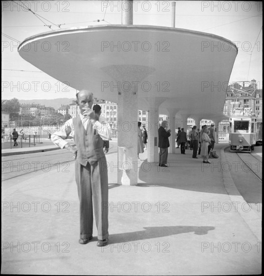 Man at tram stop Central, Zurich 1950