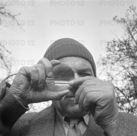 Ernst Glanzmann analyzes rock samples; 1954