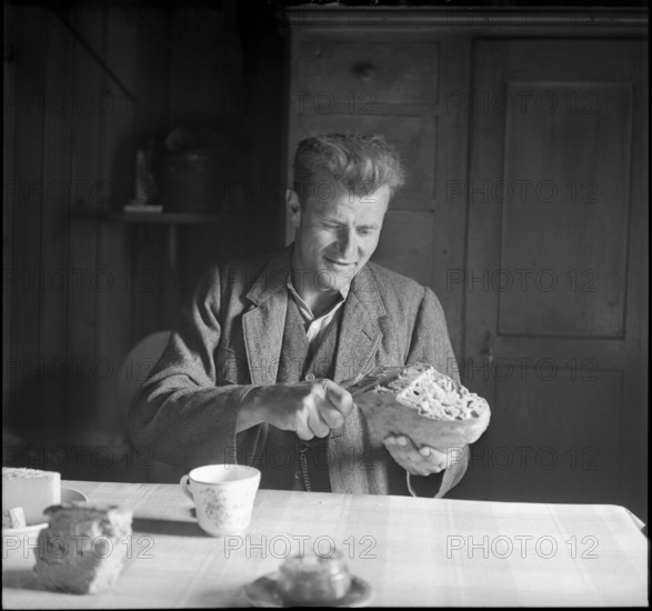 Farmer cutting bread, 1941