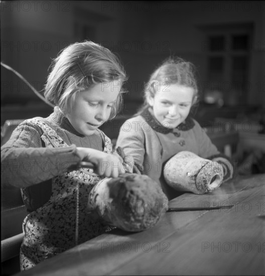 Children make pumpkin lanterns for school New Year's Eve 1945