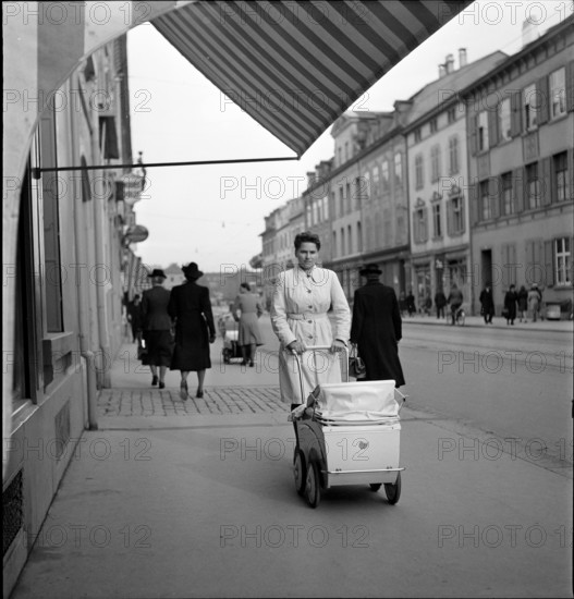 Woman with stroller walking; 1942
