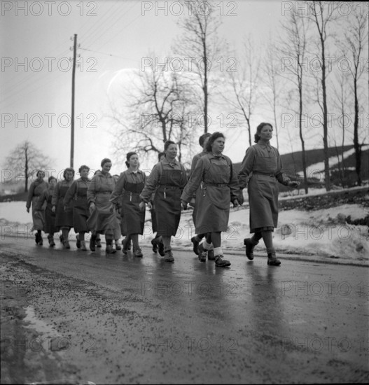 Auxiliary troops; women marching to work; 1942