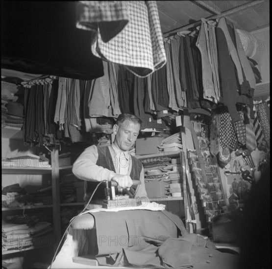 Tailor ironing Sunday suits, Oberaar power plant construction site 1951