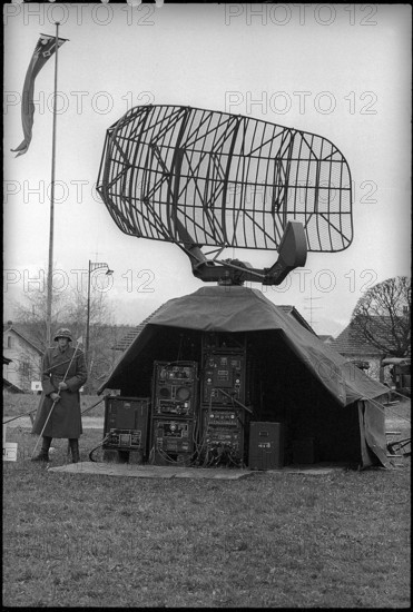 Soldier with parabolic antenna of anti-aircraft defence, Emmen 1965